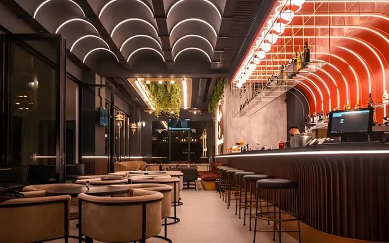 Creative bar lighting ideas combining pendant lights and neon signs to create a warm and stylish atmosphere.