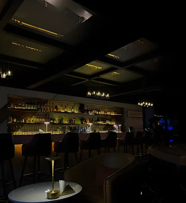 Home bar lighting ideas with backlit liquor shelves using LED lights for a cozy and elegant look.